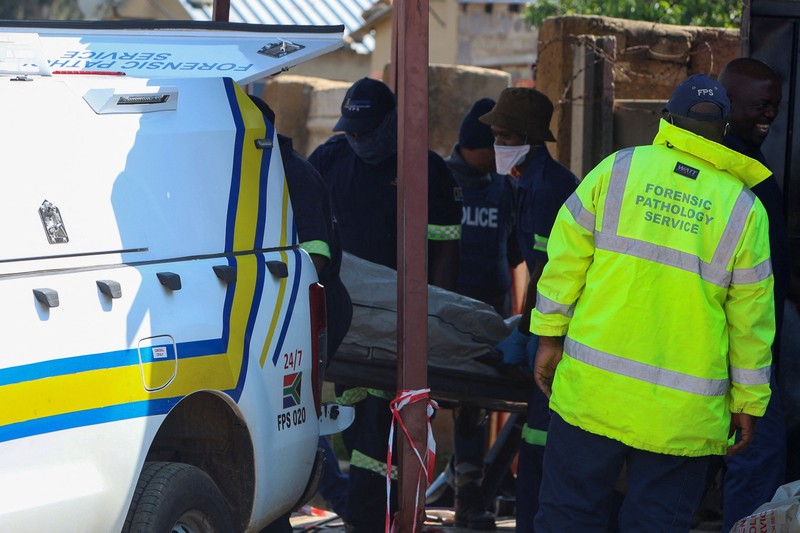 Blood stains on the ground next to an emergency vehicle at the site of a deadly shooting at a tavern in Wedela township, southwest of Johannesburg, South Africa, September 27, 2026. REUTERS/Oupa Nkosi