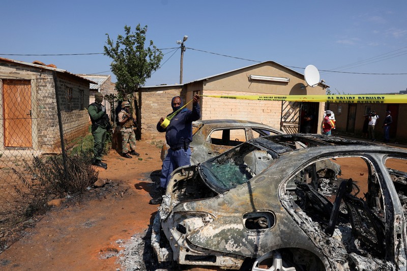 Blood stains on the ground next to an emergency vehicle at the site of a deadly shooting at a tavern in Wedela township, southwest of Johannesburg, South Africa, September 27, 2026. REUTERS/Oupa Nkosi