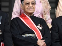Malaysia's Prime Minister Mahathir Mohamad (bottom) poses for a photo session with his wife Siti Hasmah Mohamad Ali (behind) after receiving the Grand Cordon of the Order of Paulownia Flowers during a decoration ceremony at the Imperial Palace in Tok