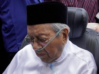 Former Malaysian prime minister Mahathir Mohamad looks at the casket of his wife, Siti Hasmah Mohamad Ali, during her funeral ceremony at As Syarif Mosque in Kuala Lumpur on September 28, 2026. Hasmah, the wife of Malaysia's longest serving two-time