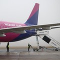 FILE PHOTO: Ground handling workers operate around a Wizz Air Airbus A321neo aircraft, registration 9H-WMI, at Warsaw-Modlin Airport in Modlin, Poland, December 1, 2025. REUTERS/Kacper Pempel/File Photo