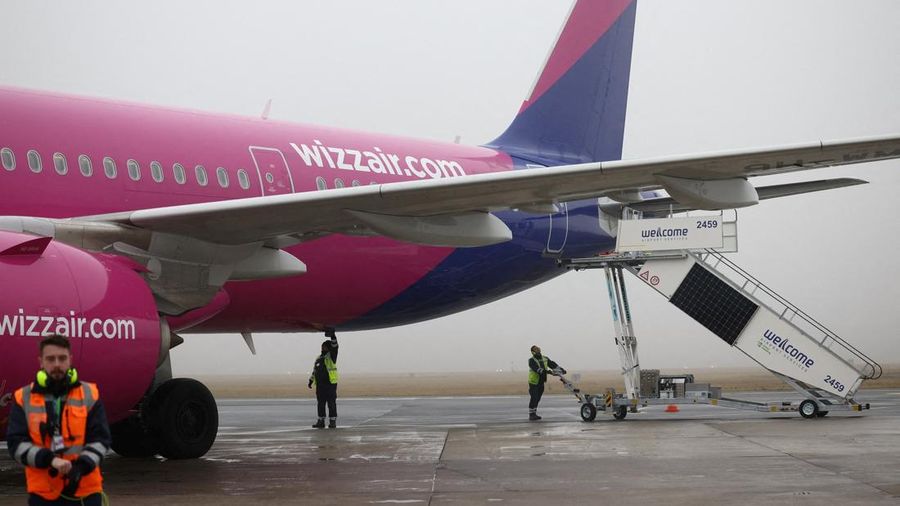 FILE PHOTO: Ground handling workers operate around a Wizz Air Airbus A321neo aircraft, registration 9H-WMI, at Warsaw-Modlin Airport in Modlin, Poland, December 1, 2025. REUTERS/Kacper Pempel/File Photo