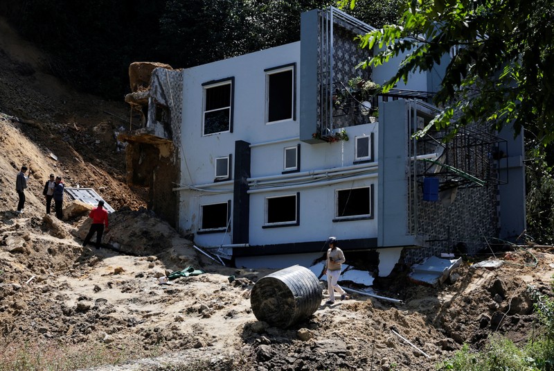 A toppled house after it was swept by a landslide, following incessant rains, in Lalitpur, Nepal, September 28, 2026. REUTERS/Navesh Chitrakar