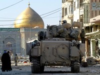 FILE PHOTO: A U.S. Army Bradley armoured vehicle of the 1st Cavalry division guards a street leading from the cemetery to Imam Ali shrine, in Najaf, Iraq, August 27, 2004. REUTERS/Chris Helgren/File Photo