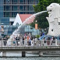 People gather around the Merlion statue at the Marina Bay waterfront in Singapore on May 13, 2024. (Photo by Roslan RAHMAN / AFP)