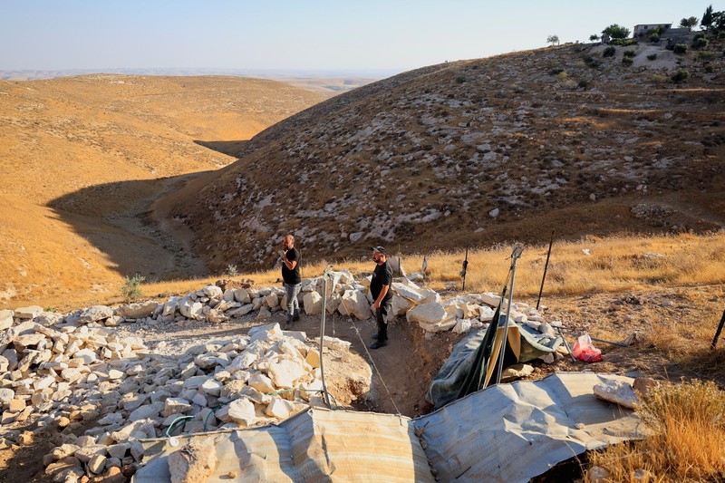 A Palestinian serves tea in a cave used as a house after Israeli forces demolished his house, in Masafer Yatta near Hebron in the Israeli-occupied West Bank, September 18, 2026. REUTERS/Mussa Qawasma