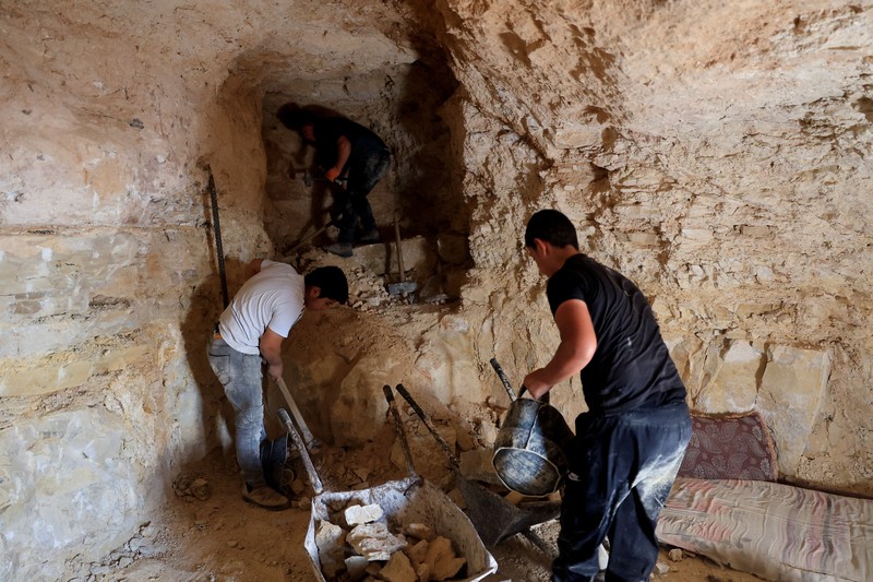A Palestinian serves tea in a cave used as a house after Israeli forces demolished his house, in Masafer Yatta near Hebron in the Israeli-occupied West Bank, September 18, 2026. REUTERS/Mussa Qawasma