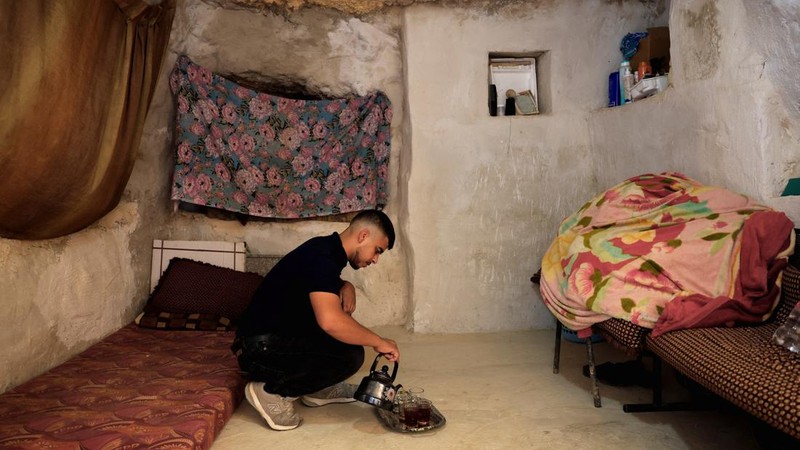 A Palestinian serves tea in a cave used as a house after Israeli forces demolished his house, in Masafer Yatta near Hebron in the Israeli-occupied West Bank, September 18, 2026. REUTERS/Mussa Qawasma