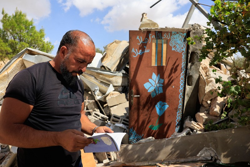 A Palestinian serves tea in a cave used as a house after Israeli forces demolished his house, in Masafer Yatta near Hebron in the Israeli-occupied West Bank, September 18, 2026. REUTERS/Mussa Qawasma