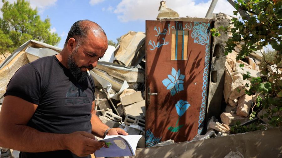 A Palestinian searches for his belongings after Israeli forces demolished his house, in Masafer Yatta near Hebron in the Israeli-occupied West Bank, September 18, 2026. REUTERS/Mussa Qawasma