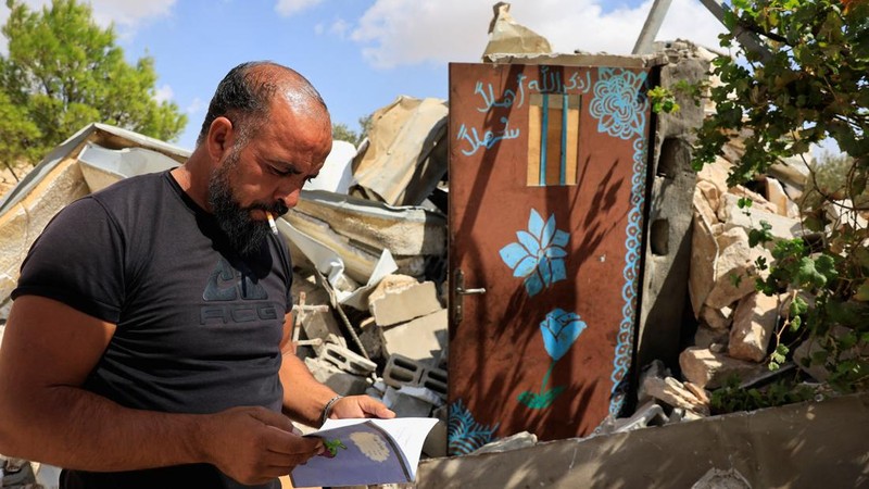 A Palestinian searches for his belongings after Israeli forces demolished his house, in Masafer Yatta near Hebron in the Israeli-occupied West Bank, September 18, 2026. REUTERS/Mussa Qawasma