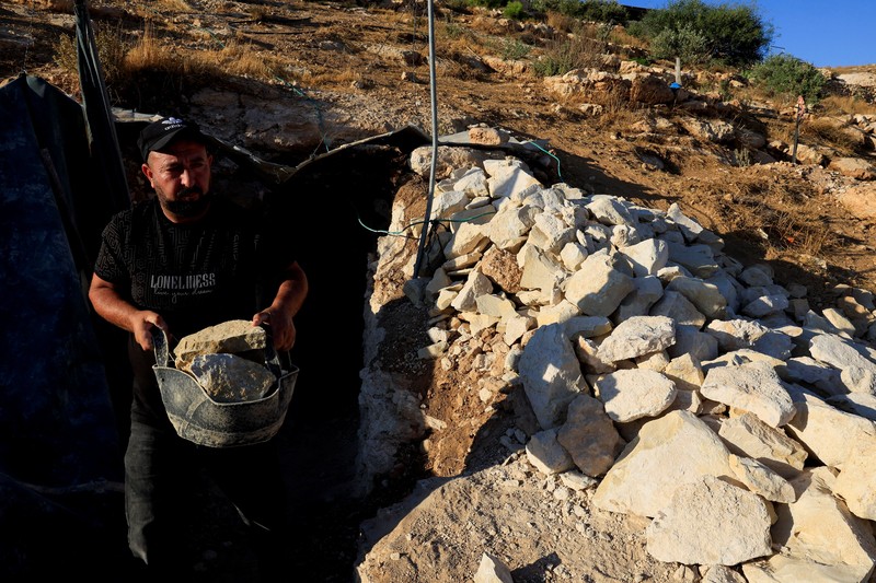 A Palestinian serves tea in a cave used as a house after Israeli forces demolished his house, in Masafer Yatta near Hebron in the Israeli-occupied West Bank, September 18, 2026. REUTERS/Mussa Qawasma