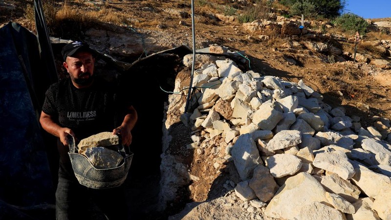 A Palestinian digs caves to live in after Israeli forces demolished their houses, in Masafer Yatta near Hebron in the Israeli-occupied West Bank, September 23, 2026. REUTERS/Mussa Qawasma