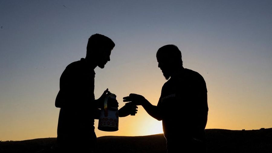 Palestinians share coffee as they dig caves to live in after Israeli forces demolished their houses, in Masafer Yatta near Hebron in the Israeli-occupied West Bank, September 23, 2026. REUTERS/Mussa Qawasma     TPX IMAGES OF THE DAY