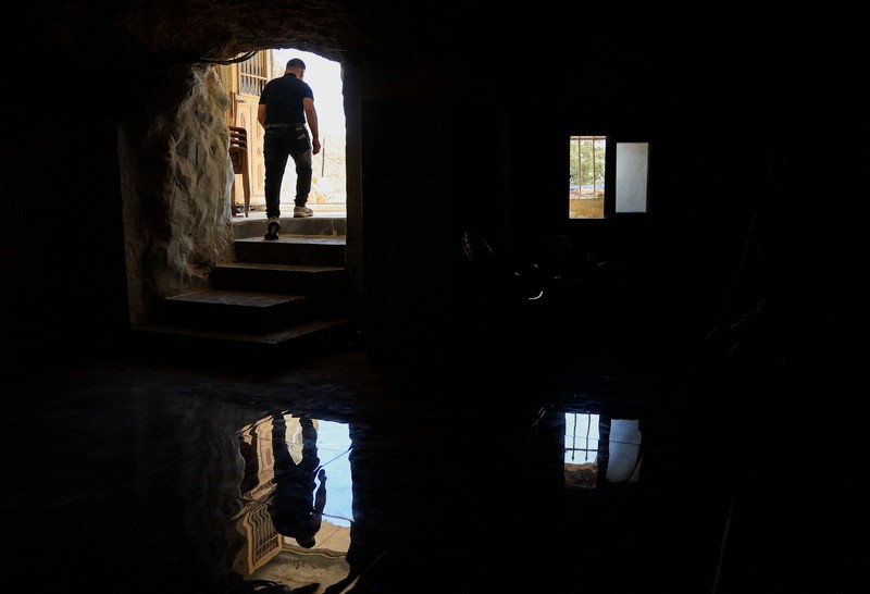 A Palestinian serves tea in a cave used as a house after Israeli forces demolished his house, in Masafer Yatta near Hebron in the Israeli-occupied West Bank, September 18, 2026. REUTERS/Mussa Qawasma