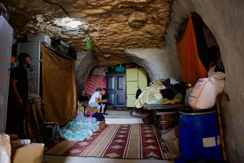 A Palestinian serves tea in a cave used as a house after Israeli forces demolished his house, in Masafer Yatta near Hebron in the Israeli-occupied West Bank, September 18, 2026. REUTERS/Mussa Qawasma