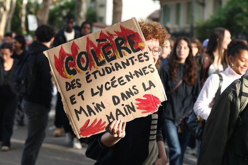 French CRS riot police stand in position in a street amid clashes during a protest by French high school and university students near Lycee Paul Eluard high-school to demand the hiring of substitute teachers, increased resources and better learning conditions, and to support the ongoing high-school student movement in the Seine-Saint-Denis department, in Saint-Denis near Paris, France, October 1, 2026.  REUTERS/Abdul Saboor