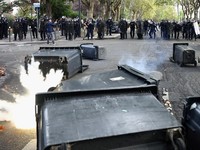 French CRS riot police stand in position in a street amid clashes during a protest by French high school and university students near Lycee Paul Eluard high-school to demand the hiring of substitute teachers, increased resources and better learning c