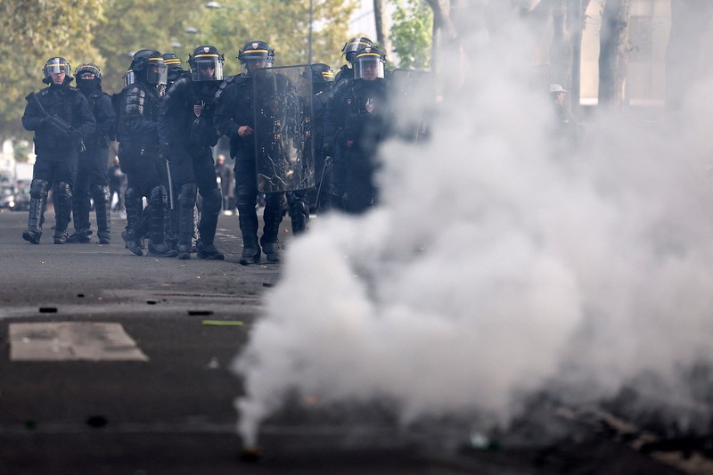 French CRS riot police stand in position in a street amid clashes during a protest by French high school and university students near Lycee Paul Eluard high-school to demand the hiring of substitute teachers, increased resources and better learning conditions, and to support the ongoing high-school student movement in the Seine-Saint-Denis department, in Saint-Denis near Paris, France, October 1, 2026.  REUTERS/Abdul Saboor
