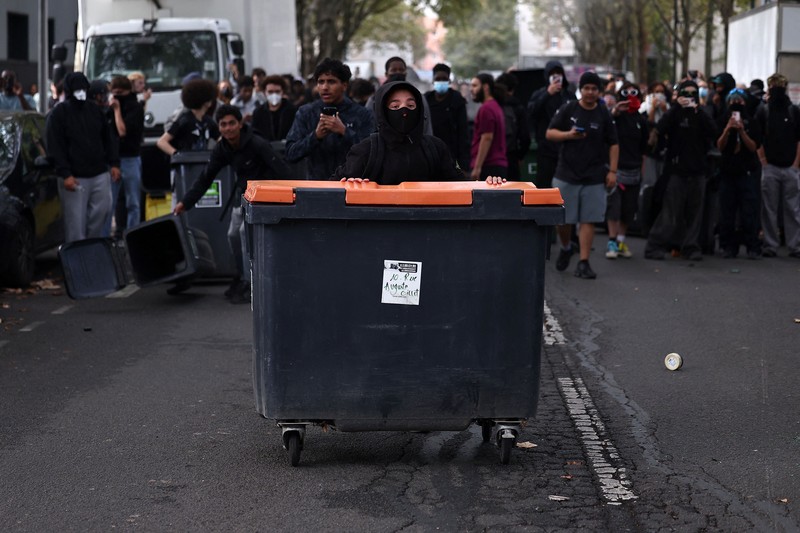 French CRS riot police stand in position in a street amid clashes during a protest by French high school and university students near Lycee Paul Eluard high-school to demand the hiring of substitute teachers, increased resources and better learning conditions, and to support the ongoing high-school student movement in the Seine-Saint-Denis department, in Saint-Denis near Paris, France, October 1, 2026.  REUTERS/Abdul Saboor
