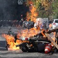 View of burning Velib bicycle, garbage bins and objects set up by high school and university students in a street amid clashes with French riot police during a student protest to demand the hiring of substitute teachers, increased resources and bette