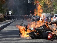 View of burning Velib bicycle, garbage bins and objects set up by high school and university students in a street amid clashes with French riot police during a student protest to demand the hiring of substitute teachers, increased resources and bette