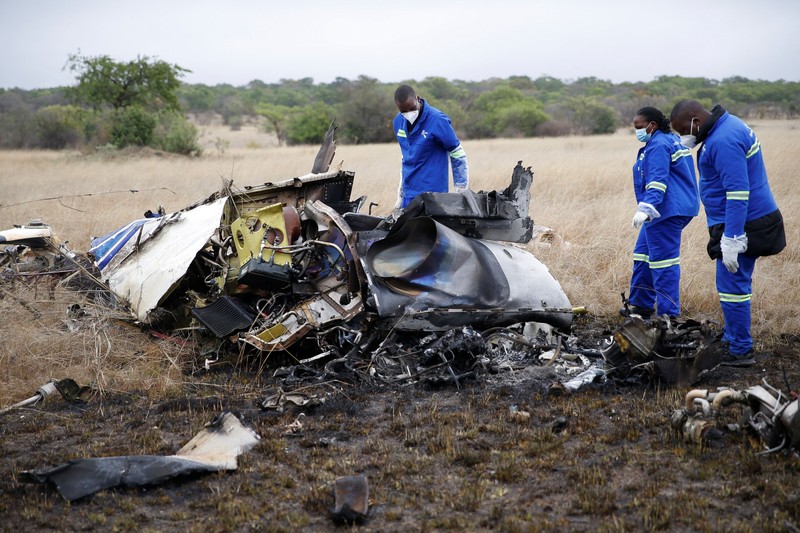 Officials work at the site of a helicopter crash at Kudenga Farm in the Marondera rural area, east of Harare, Zimbabwe, October 1, 2026. REUTERS/Philimon Bulawayo