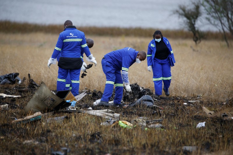 Officials work at the site of a helicopter crash at Kudenga Farm in the Marondera rural area, east of Harare, Zimbabwe, October 1, 2026. REUTERS/Philimon Bulawayo