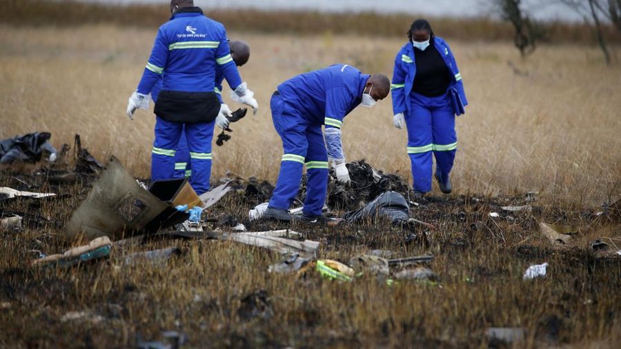 Officials work at the site of a helicopter crash at Kudenga Farm in the Marondera rural area, east of Harare, Zimbabwe, October 1, 2026. REUTERS/Philimon Bulawayo     TPX IMAGES OF THE DAY