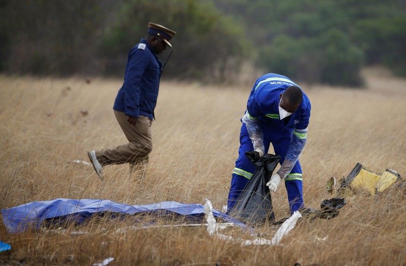 Officials work at the site of a helicopter crash at Kudenga Farm in the Marondera rural area, east of Harare, Zimbabwe, October 1, 2026. REUTERS/Philimon Bulawayo