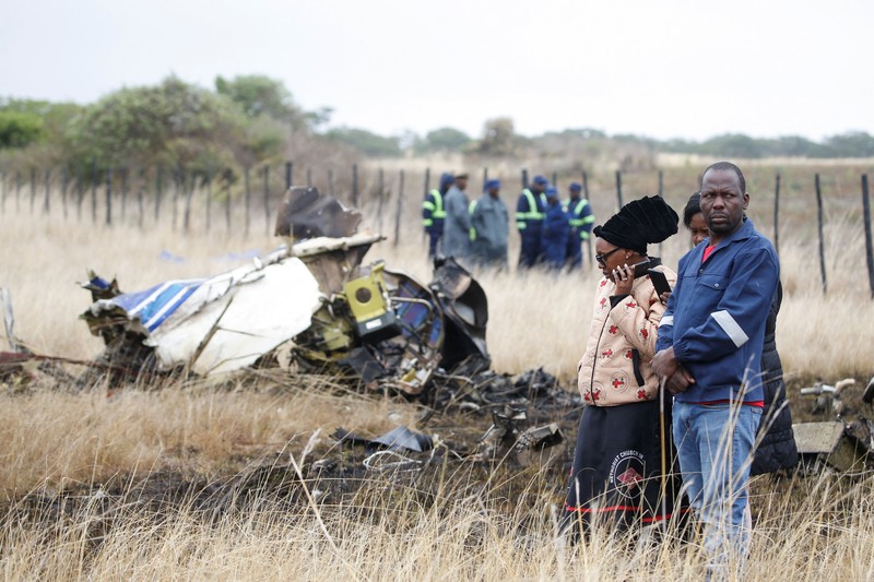 Officials work at the site of a helicopter crash at Kudenga Farm in the Marondera rural area, east of Harare, Zimbabwe, October 1, 2026. REUTERS/Philimon Bulawayo
