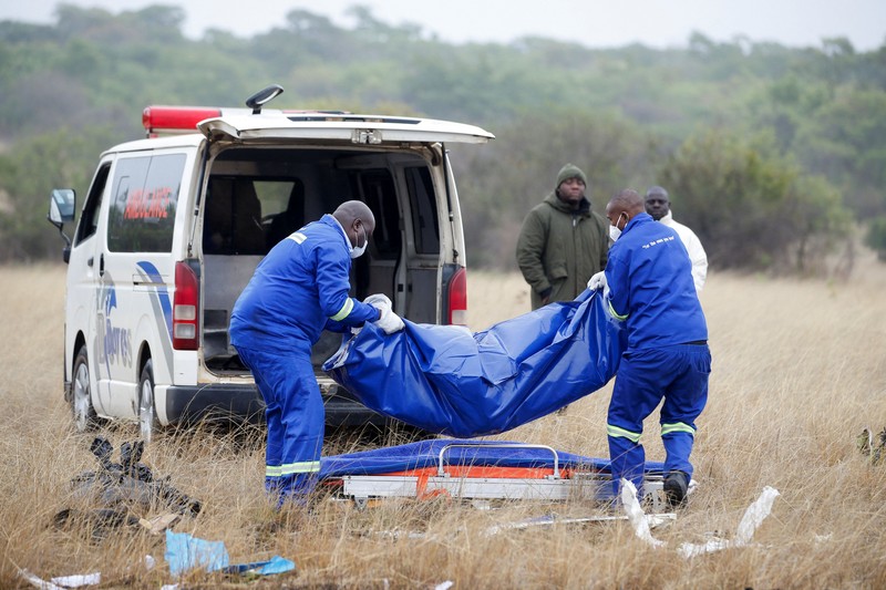 Officials work at the site of a helicopter crash at Kudenga Farm in the Marondera rural area, east of Harare, Zimbabwe, October 1, 2026. REUTERS/Philimon Bulawayo