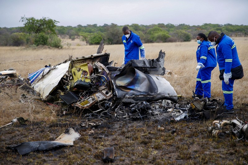 Officials work at the site of a helicopter crash at Kudenga Farm in the Marondera rural area, east of Harare, Zimbabwe, October 1, 2026. REUTERS/Philimon Bulawayo
