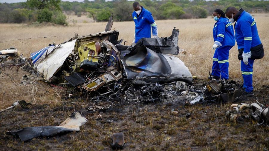 Officials work at the site of a helicopter crash at Kudenga Farm in the Marondera rural area, east of Harare, Zimbabwe, October 1, 2026. REUTERS/Philimon Bulawayo     TPX IMAGES OF THE DAY