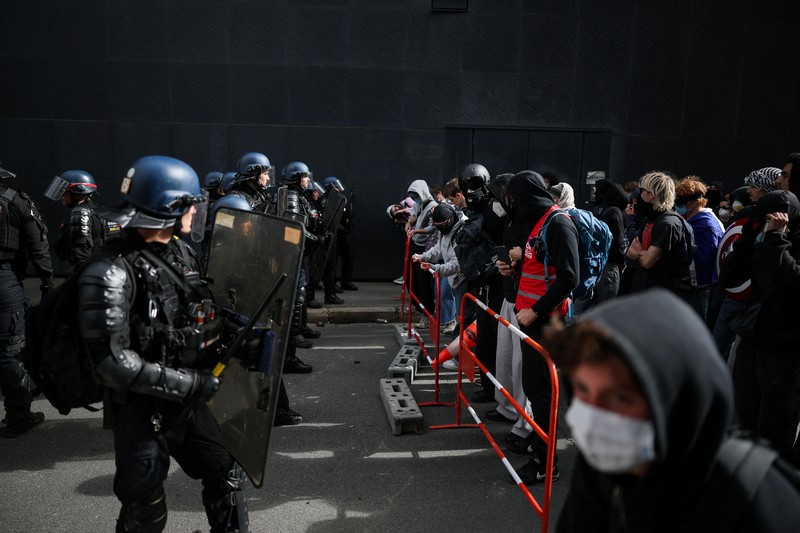 A person carries the French national flag as French high school and university students attend a demonstration in Nantes, part of a nationwide day of protests and blockades to demand better school conditions in France, October 8, 2026. REUTERS/Stephane Mahe