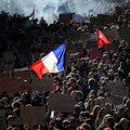 A person carries the French national flag as French high school and university students attend a demonstration in Nantes, part of a nationwide day of protests and blockades to demand better school conditions in France, October 8, 2026. REUTERS/Stepha
