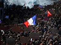 A person carries the French national flag as French high school and university students attend a demonstration in Nantes, part of a nationwide day of protests and blockades to demand better school conditions in France, October 8, 2026. REUTERS/Stepha