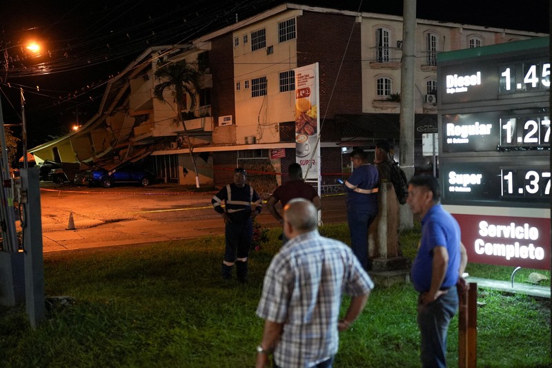 Warga berdiri di dekat mobil-mobil yang rusak akibat tertimpa reruntuhan setelah gempa bumi melanda dekat pesisir selatan Panama, di Penonome, Panama, pada 9 Oktober 2026. (REUTERS/Enea Lebrun)