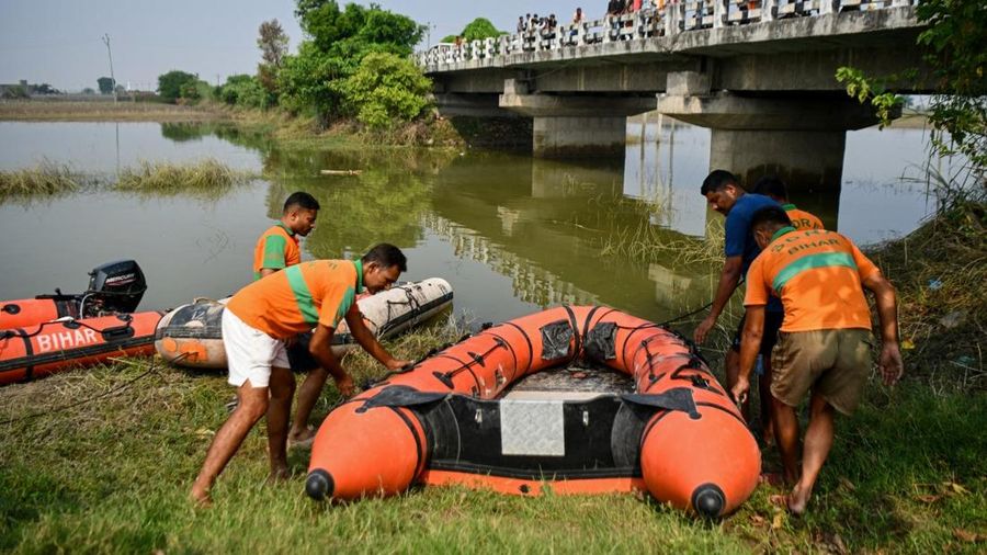 Rescue personnel prepare to conduct a search operation for the missing after a boat capsized in Ganga river in Bihar's Vaishali district on October 14, 2026. Rescuers dragged out 13 dead children from India's Ganges river after a boat capsized en rou