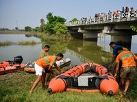 Rescue personnel prepare to conduct a search operation for the missing after a boat capsized in Ganga river in Bihar's Vaishali district on October 14, 2026. Rescuers dragged out 13 dead children from India's Ganges river after a boat capsized en rou