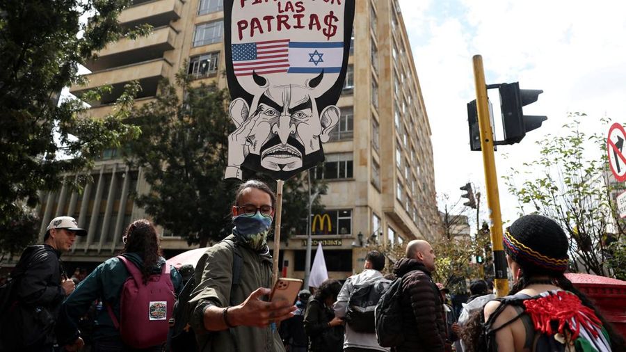 A demonstrator holds a placard reading "Steadfast for the homelands", bearing the flags of the United States and Israel, and depicting Colombian President Abelardo de la Espriella, during a nationwide protest against his government and its proposed l