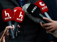 Halk TV microphones are pictured as presenter Serhan Asker, (not pictured), speaks to the media outside the broadcaster's Ankara bureau after Turkish authorities appointed a government trustee to run the pro-opposition broadcaster, in Ankara, Turkey,