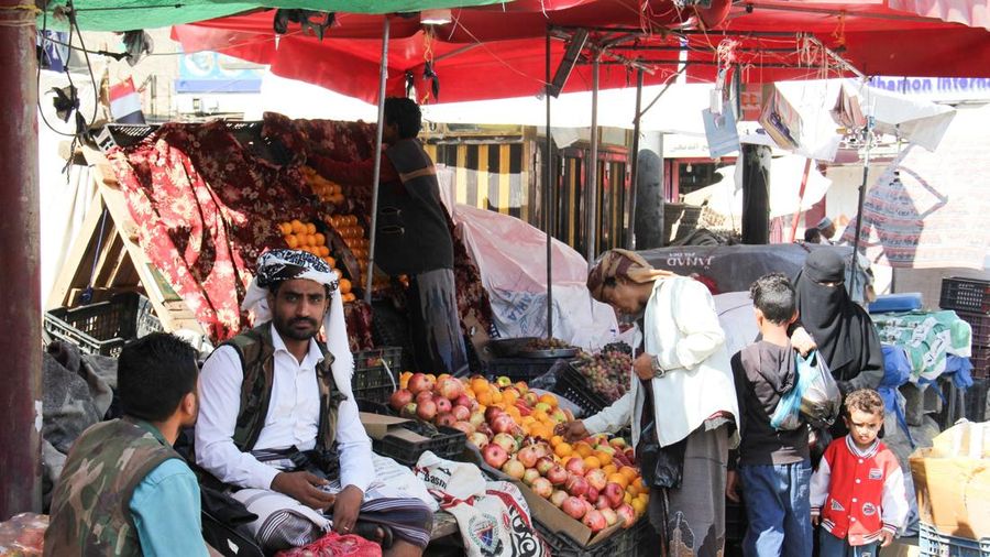 Warga Yaman berbelanja bahan pangan sementara para pedagang duduk di sebuah pasar di Taiz, Yaman, 16 Oktober 2026.