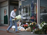 A woman leaves flowers outside the electoral office of independent Australian lawmaker Helen Haines, who was deliberately struck by a car outside her office on Monday, in Wangaratta, Australia, October 20, 2026.    AAP/James Ross via REUTERS    ATTEN