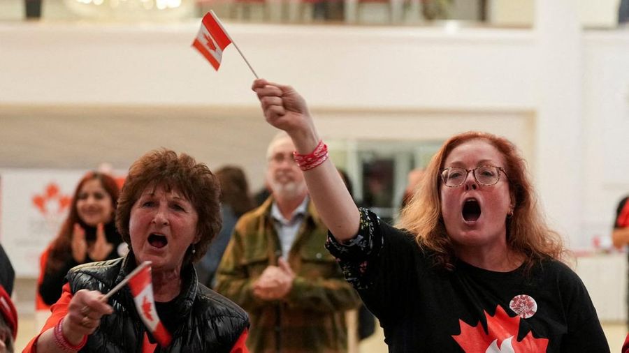 Supporters of the Forever Canadian group, who want Alberta to remain in Canada, wave Canadian flags as they watch the results of a non-binding referendum on Alberta sovereignty in Edmonton, Alberta, Canada October 19, 2026. REUTERS/Todd Korol