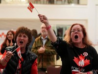 Supporters of the Forever Canadian group, who want Alberta to remain in Canada, wave Canadian flags as they watch the results of a non-binding referendum on Alberta sovereignty in Edmonton, Alberta, Canada October 19, 2026. REUTERS/Todd Korol