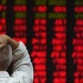 An investor watches stock price movements at a securities company in Beijing on June 15, 2016. China on June 15 brushed off stock index firm MSCI's decision to exclude the country's A shares from its influential global equities index, saying that the