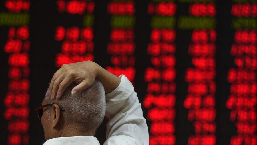 An investor watches stock price movements at a securities company in Beijing on June 15, 2016. China on June 15 brushed off stock index firm MSCI's decision to exclude the country's A shares from its influential global equities index, saying that the