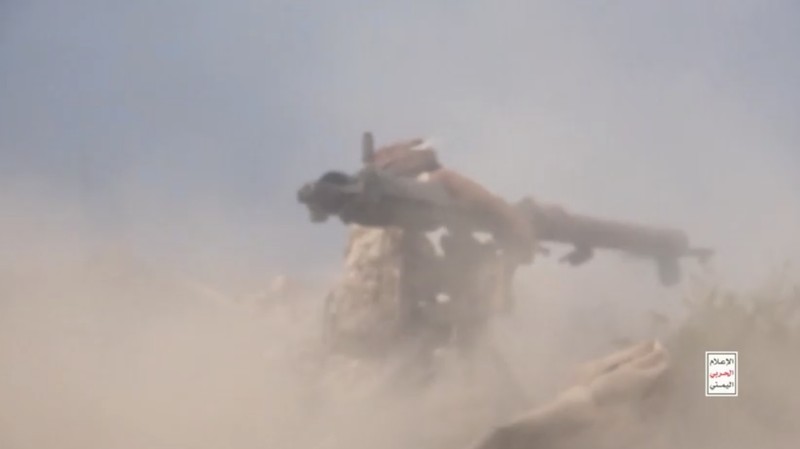 Members of Houthi military stand next to ordnance sitting on a hill amid what Houthi Military Media says are clashes between Houthi fighters and Saudi-backed Yemeni government forces in a location given as Taiz, Yemen, in this screengrab from a video