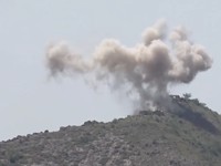 Members of Houthi military stand next to ordnance sitting on a hill amid what Houthi Military Media says are clashes between Houthi fighters and Saudi-backed Yemeni government forces in a location given as Taiz, Yemen, in this screengrab from a video